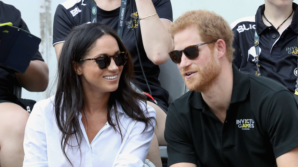 Meghan Markle and Prince Harry speaking to reporters