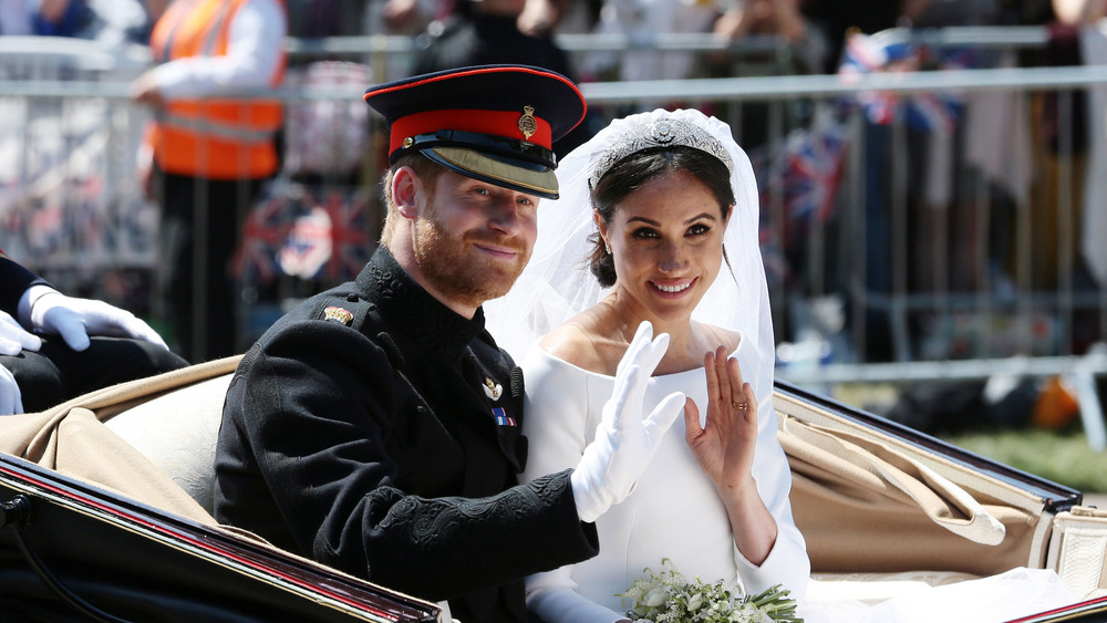 Meghan Markle and Prince Harry waving at their wedding