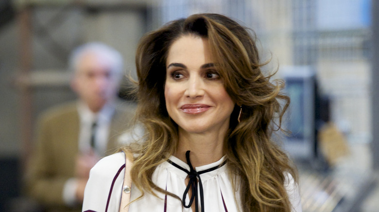 Queen Rania smiling in a white top