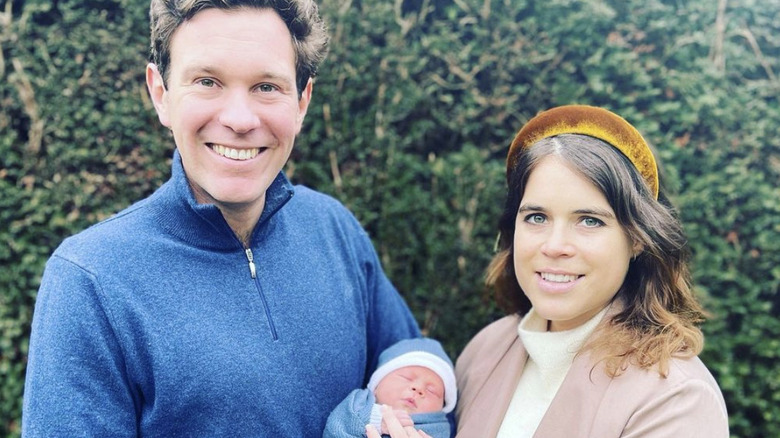 Jack Brooksbank and Princess Eugenie holding baby August