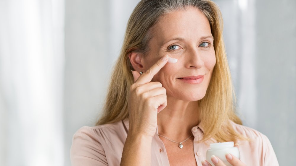 a woman applying a beauty product