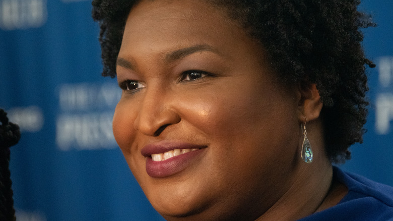 Stacey Abrams looking off and smiling