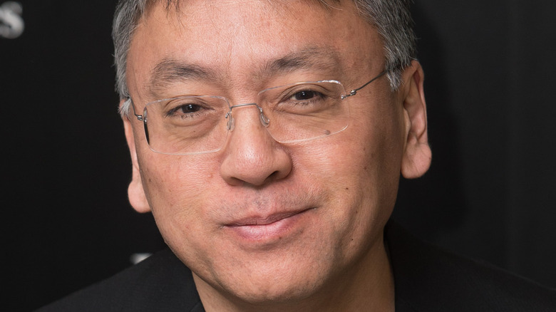 Kazuo Ishiguro smiling with book