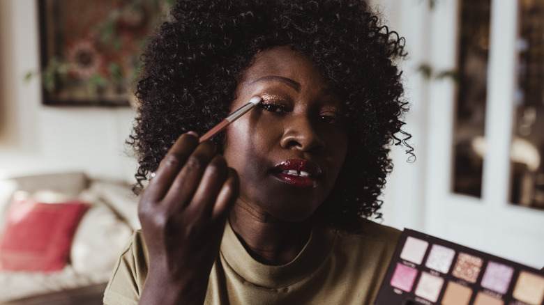 Woman applying eyeshadow