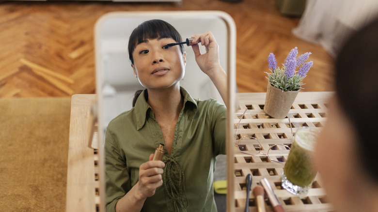 Woman applying mascara