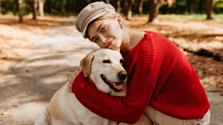 Woman hugging dog in park