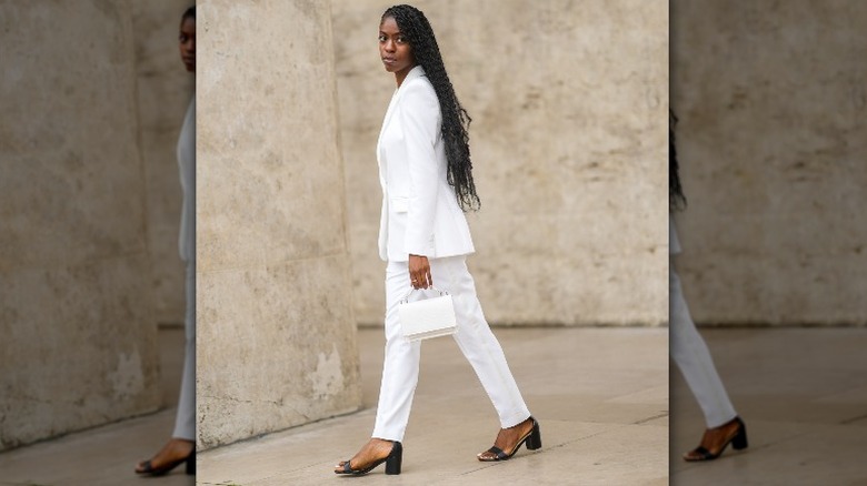 woman in white pantsuit