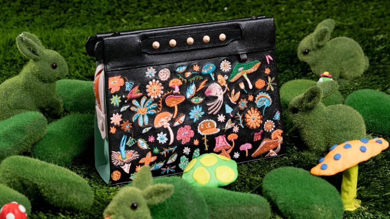 Black clutch with colorful botanical theme