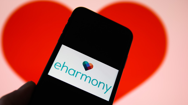 Heart behind smartphone eHarmony logo