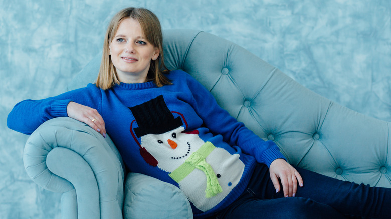 Pregnant woman wearing snowman sweater