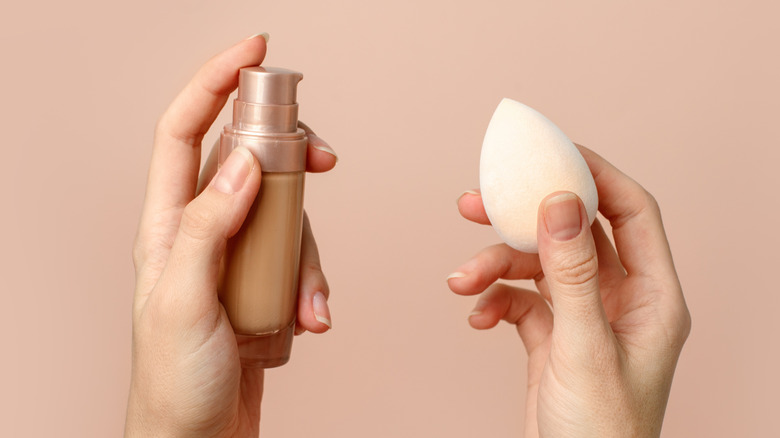 Woman holding foundation beauty sponge