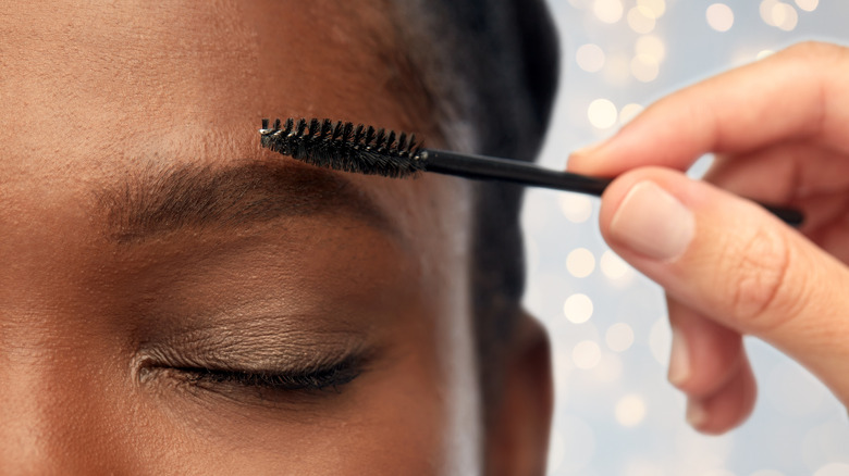 woman applying eyebrow gel