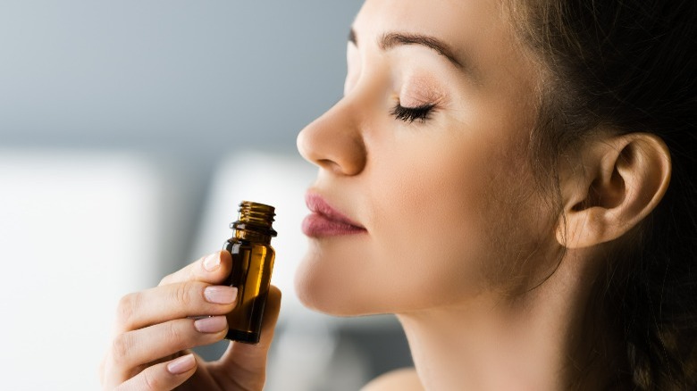 Woman smelling essential oil