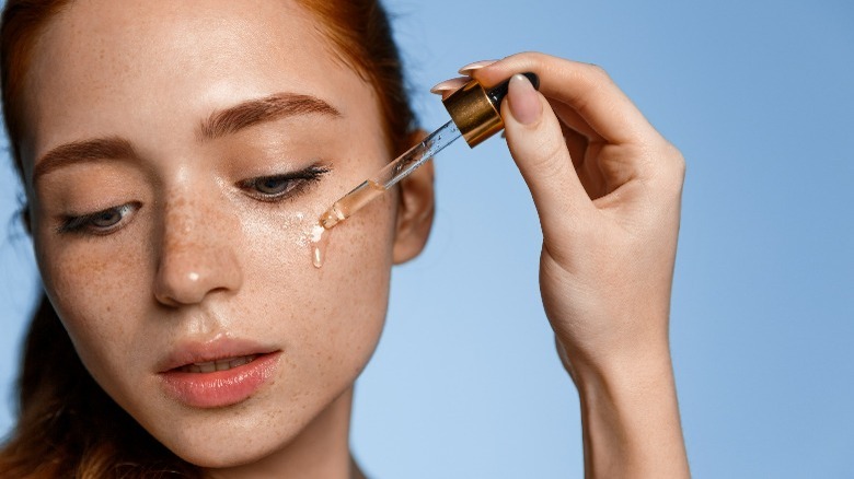 woman applying face oil