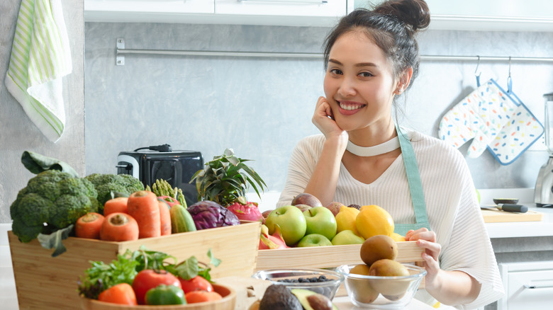 Young woman smiling with vegan ingredients