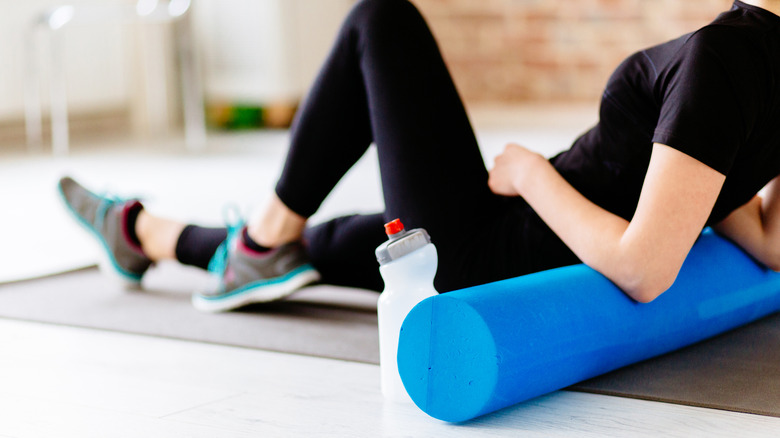 Woman using foam roller after workout