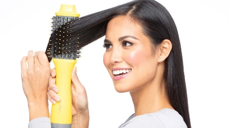 Woman using Drybar dryer