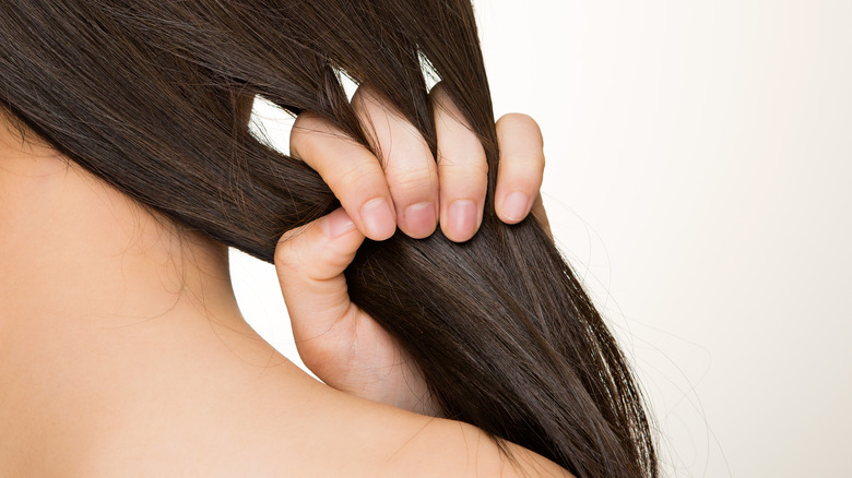 Woman combs hair with fingers