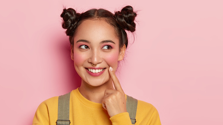 Smiling woman with pigtail buns