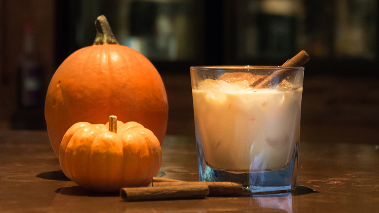 Pumpkin spice cocktail with cinnamon stick garnish