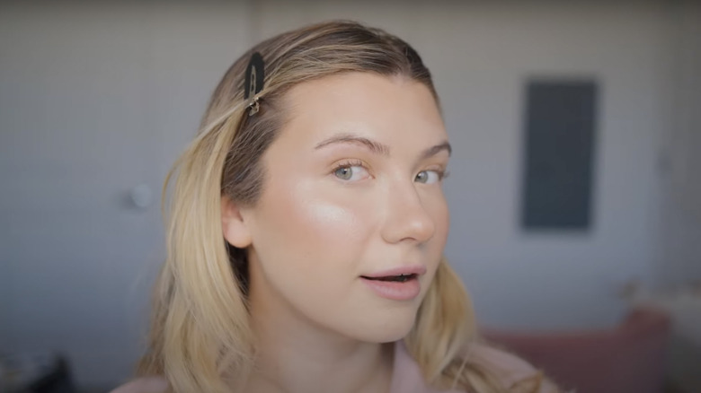 Woman showing off highlighter on cheek