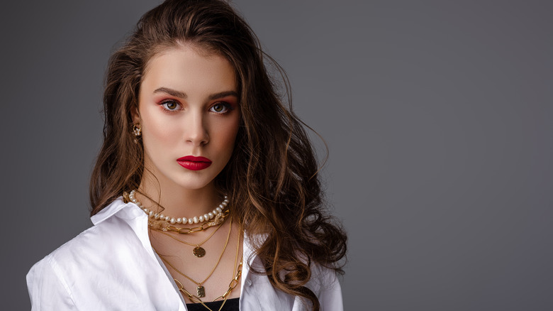 Woman with rectangular face and necklaces