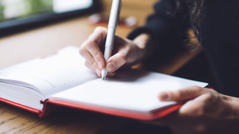 woman writing in notebook