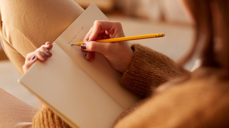 woman writing in journal