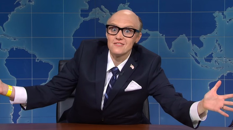 A balding Kate McKinnon with manic eyes at the "Weekend Update" desk as Rudy Giuliani