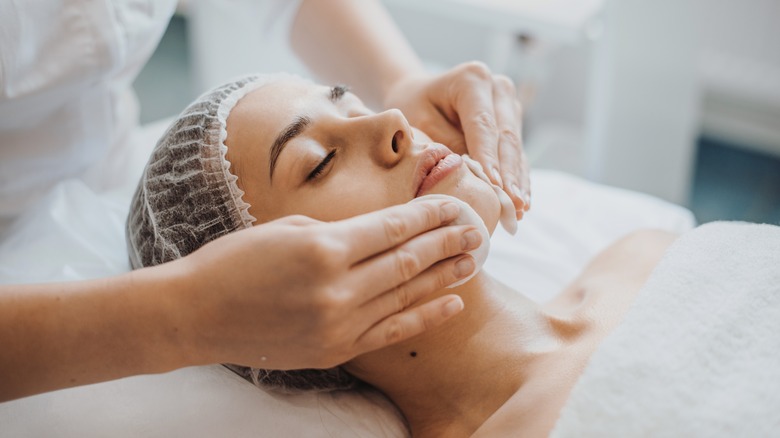 Woman receiving facial treatment