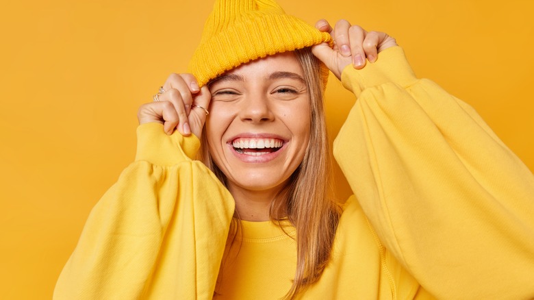 Woman smiling in yellow outfit