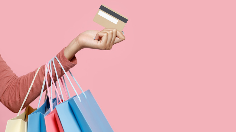 Hand holding credit card shopping bags