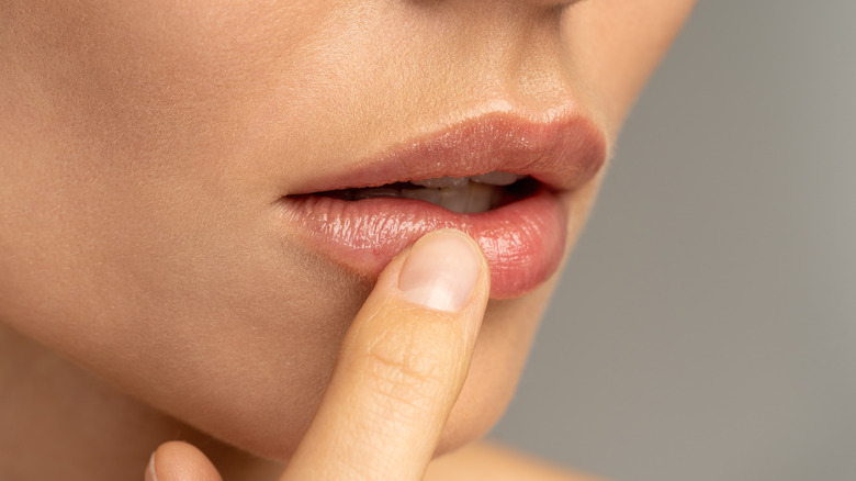 Woman applying lip balm