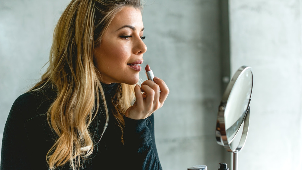 Putting on lipstick