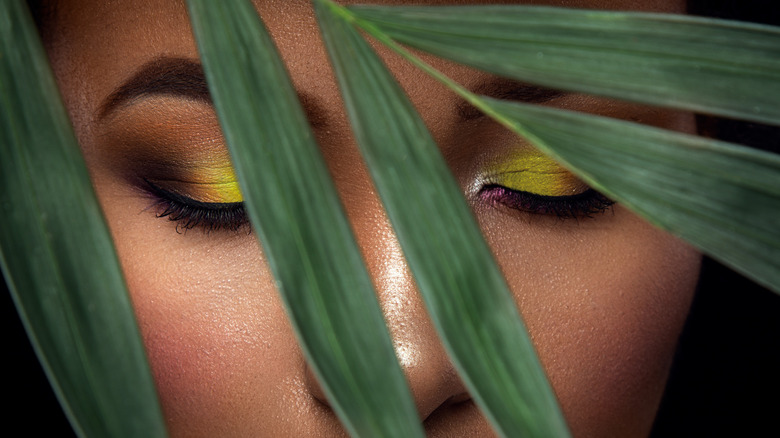 Woman with bold yellow-green eyeshadow