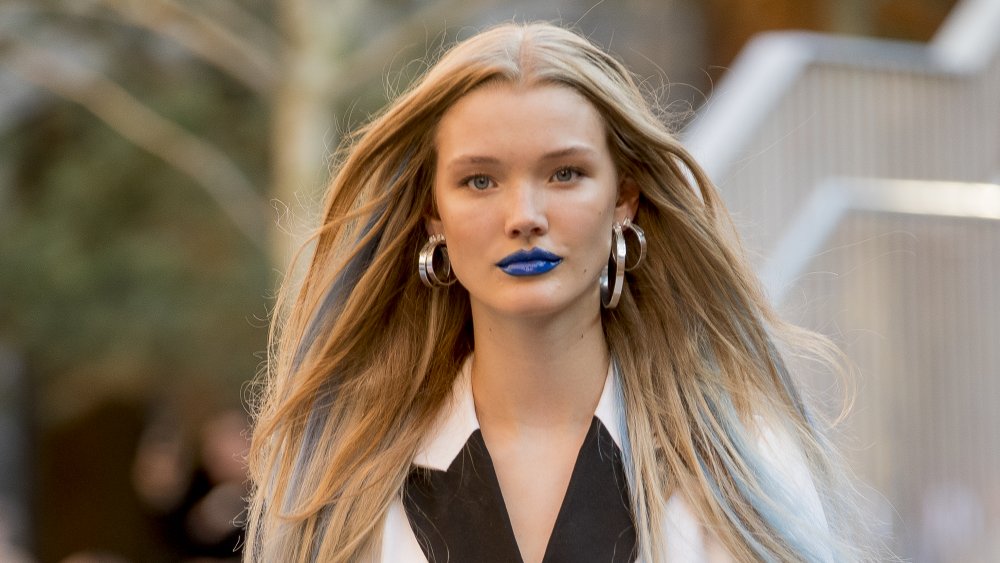 A woman wearing blue lipstick