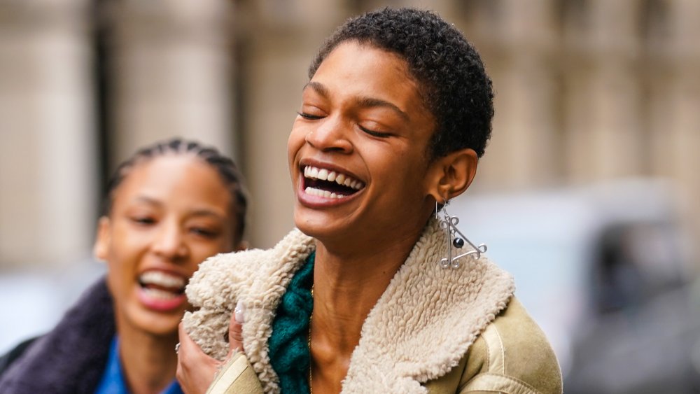 A woman with dewy skin, smiling