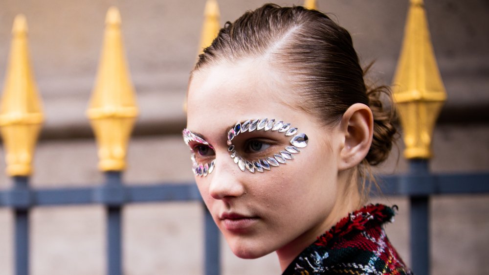 A woman with jewels around her eyes