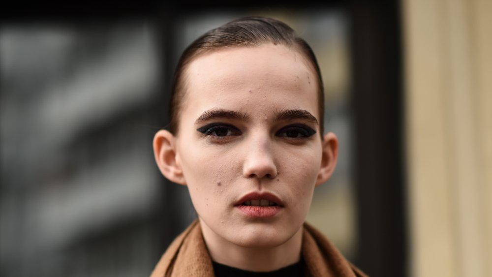 A woman wearing bold eye makeup