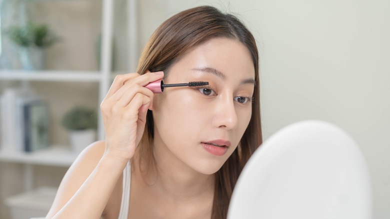 woman applying mascara