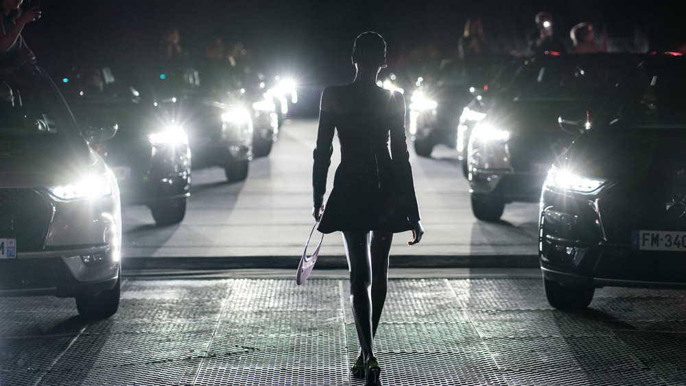 A woman walking on a street for Coperni