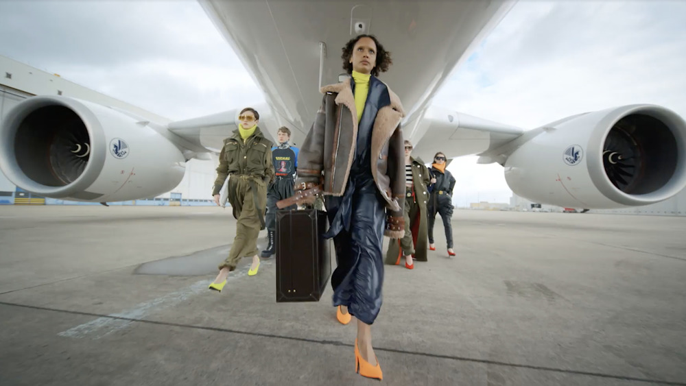 Models walking under a plane for Balmain