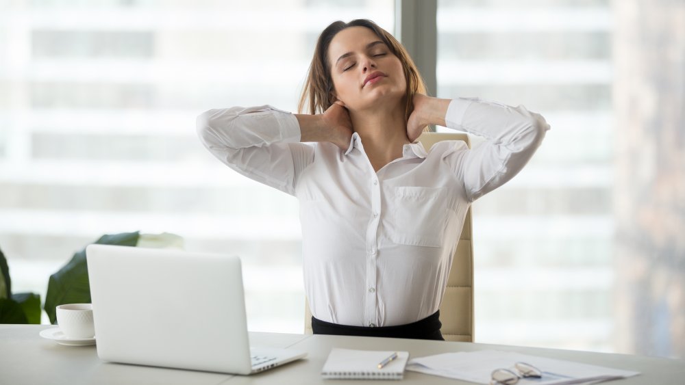 Woman seated with neck pain