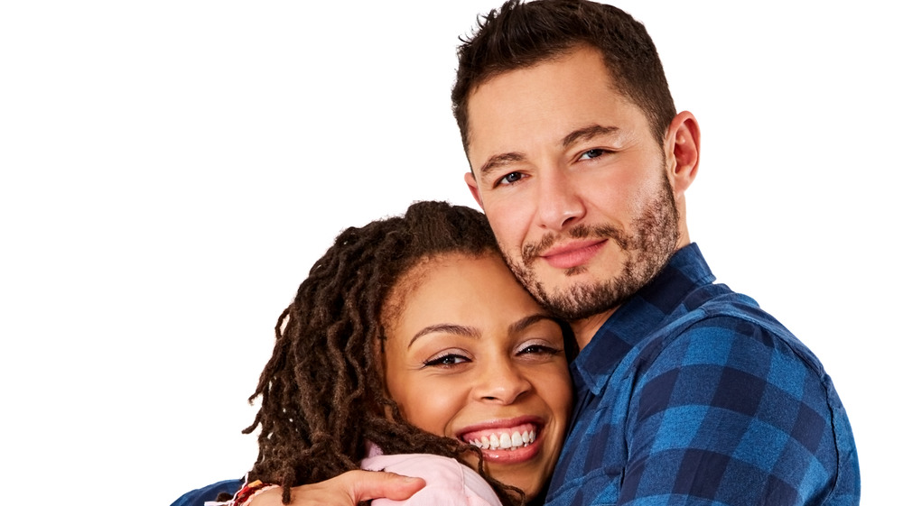 A transgender man and his partner hugging