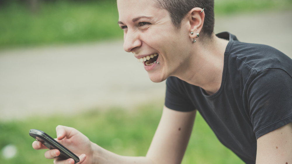 A queer woman on her phone