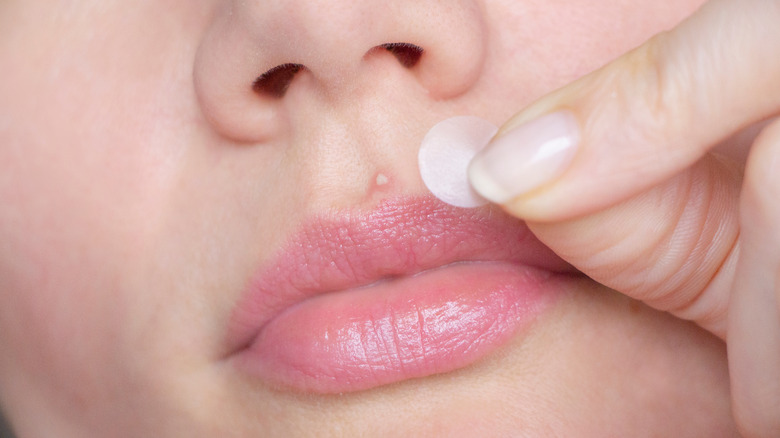 woman using pimple patch