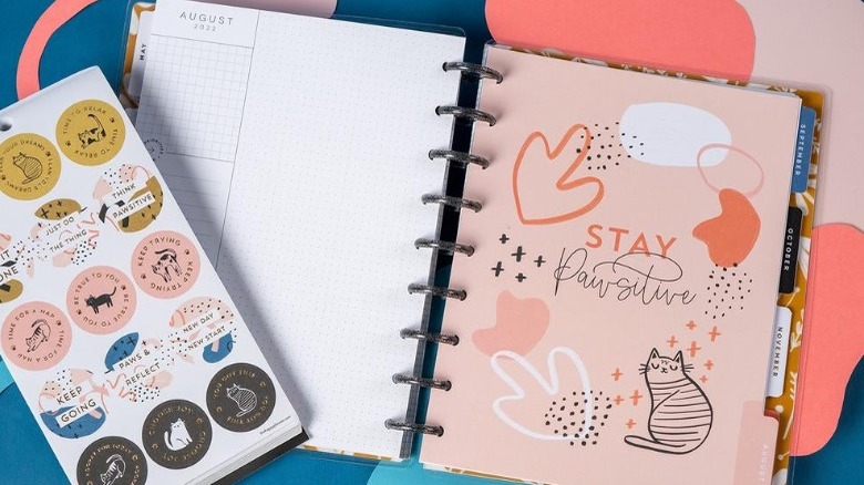 Cat-themed happy planner open with stickers