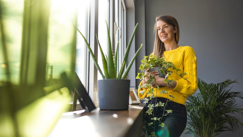 woman holding plants