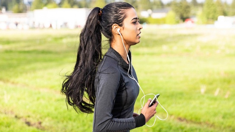 woman running cellphone headphones