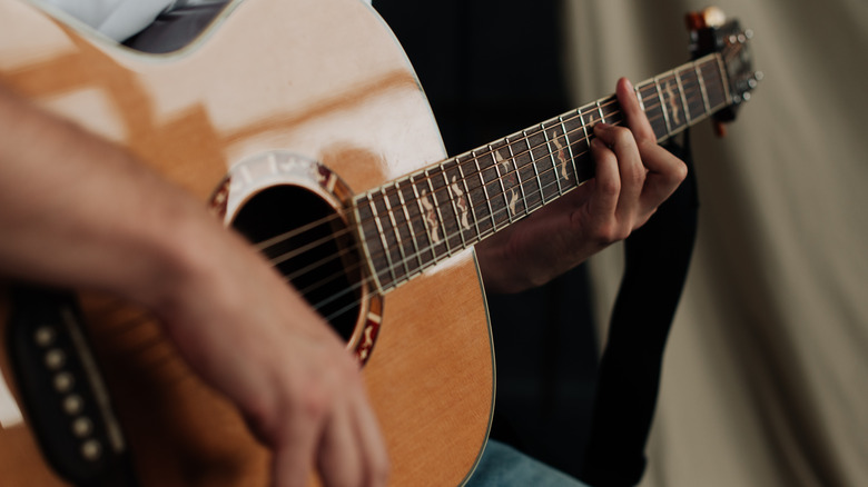 Man strumming guitar